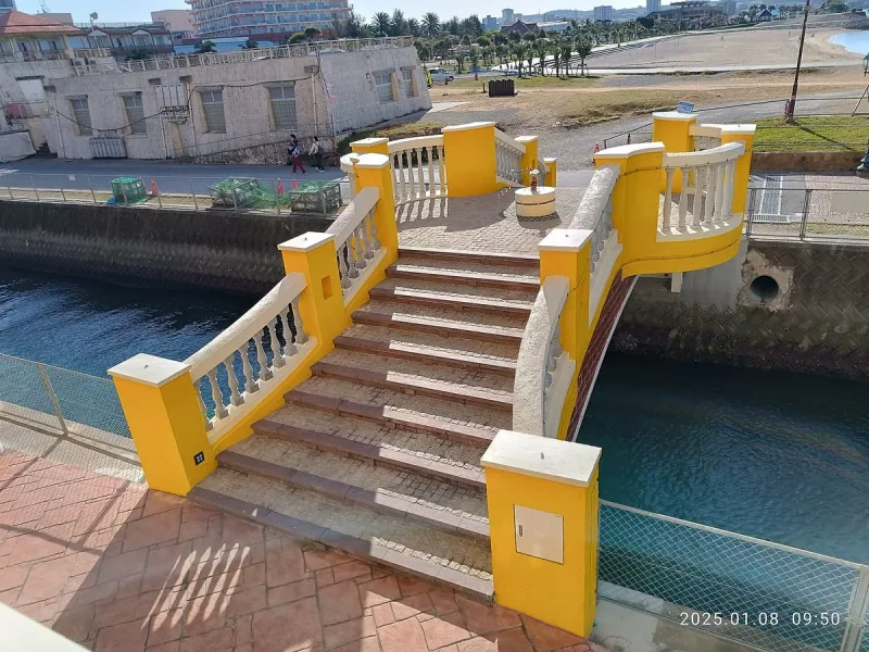 Steps on a yellow footbridge near Chatan Sunset Beach